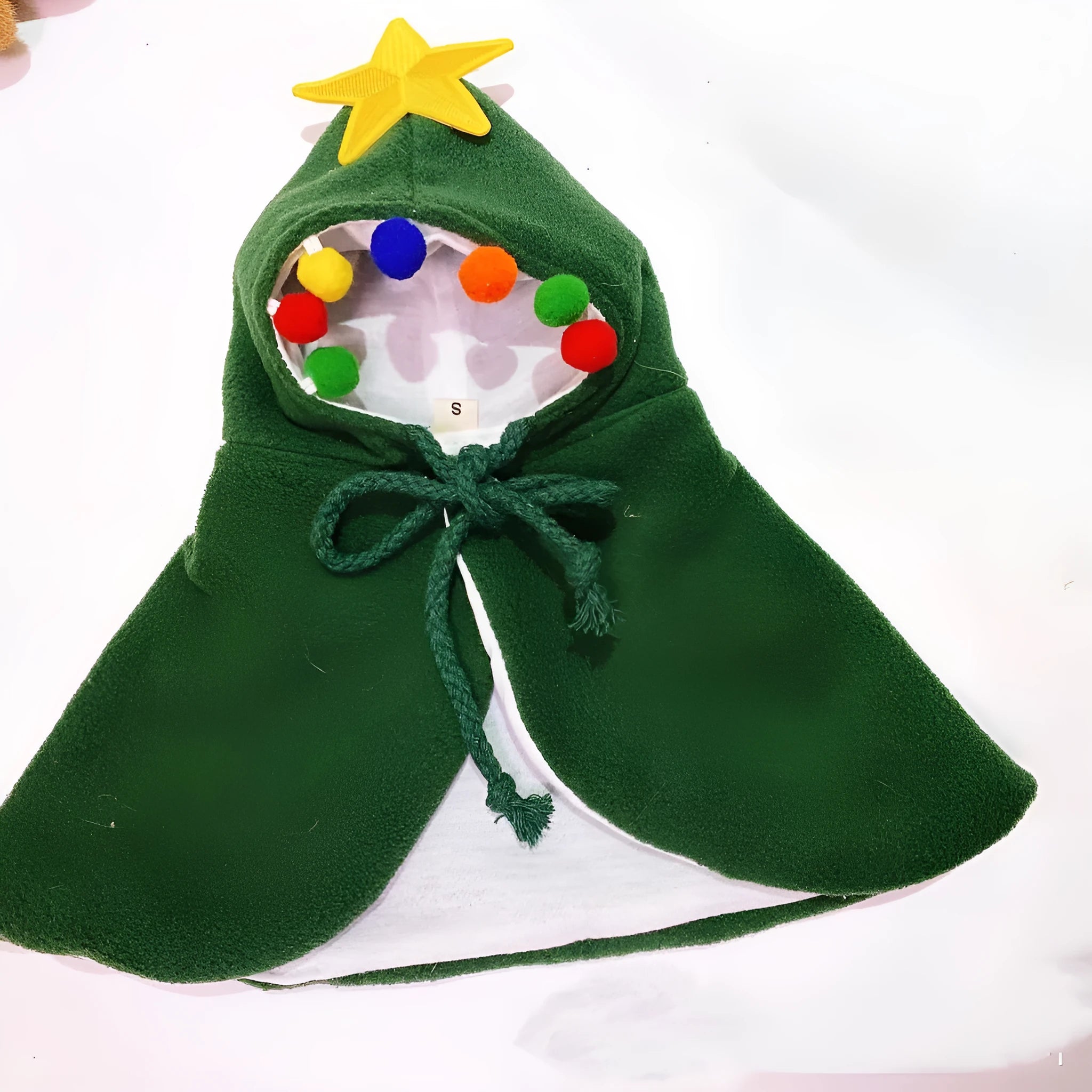 Red cloth shawl cloak clothing on a small dog with Christmas pattern background