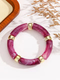 Acrylic bent tube bracelet in ten colours including black, blue, red, green, purple and white grey.