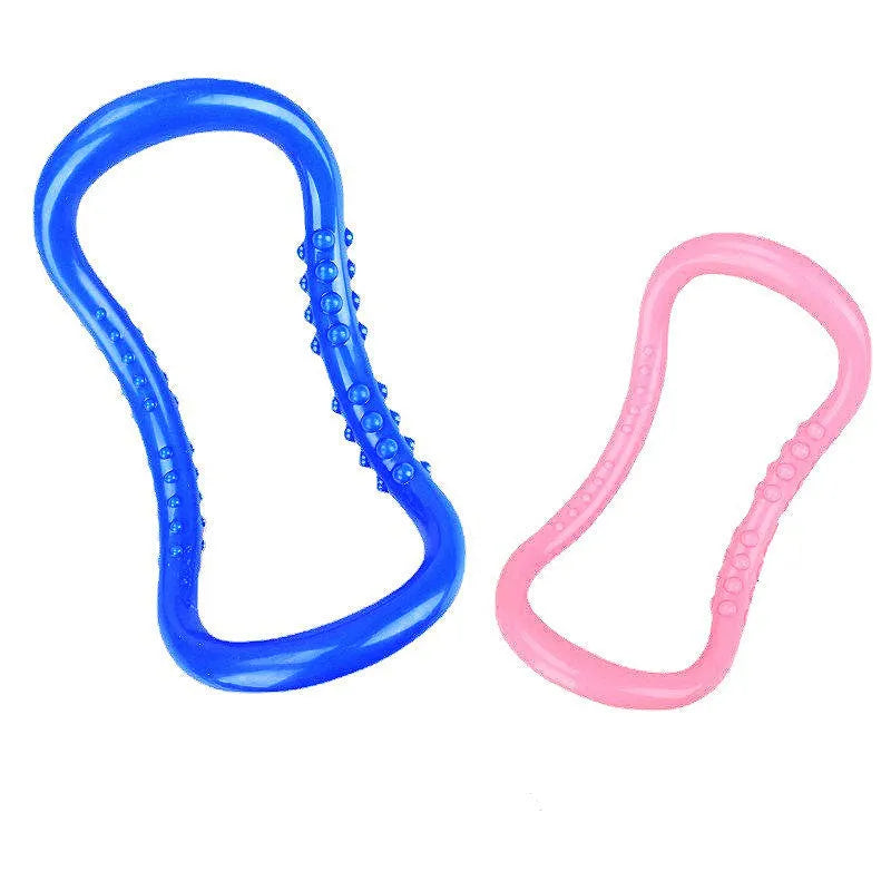 A purple PP plastic yoga ring or Pilates stretching roller on a plain background.