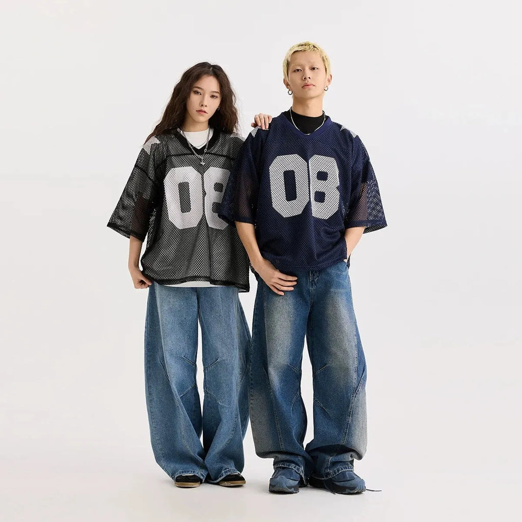 Loose fit black pullover shirt with white letters pattern print, short sleeves, on a hanger.