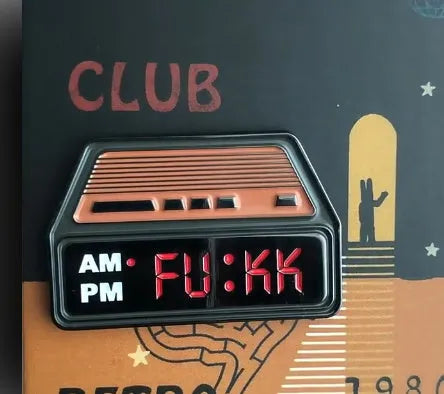 Black metal retro electronic alarm clock brooch pin with original design on a jacket lapel