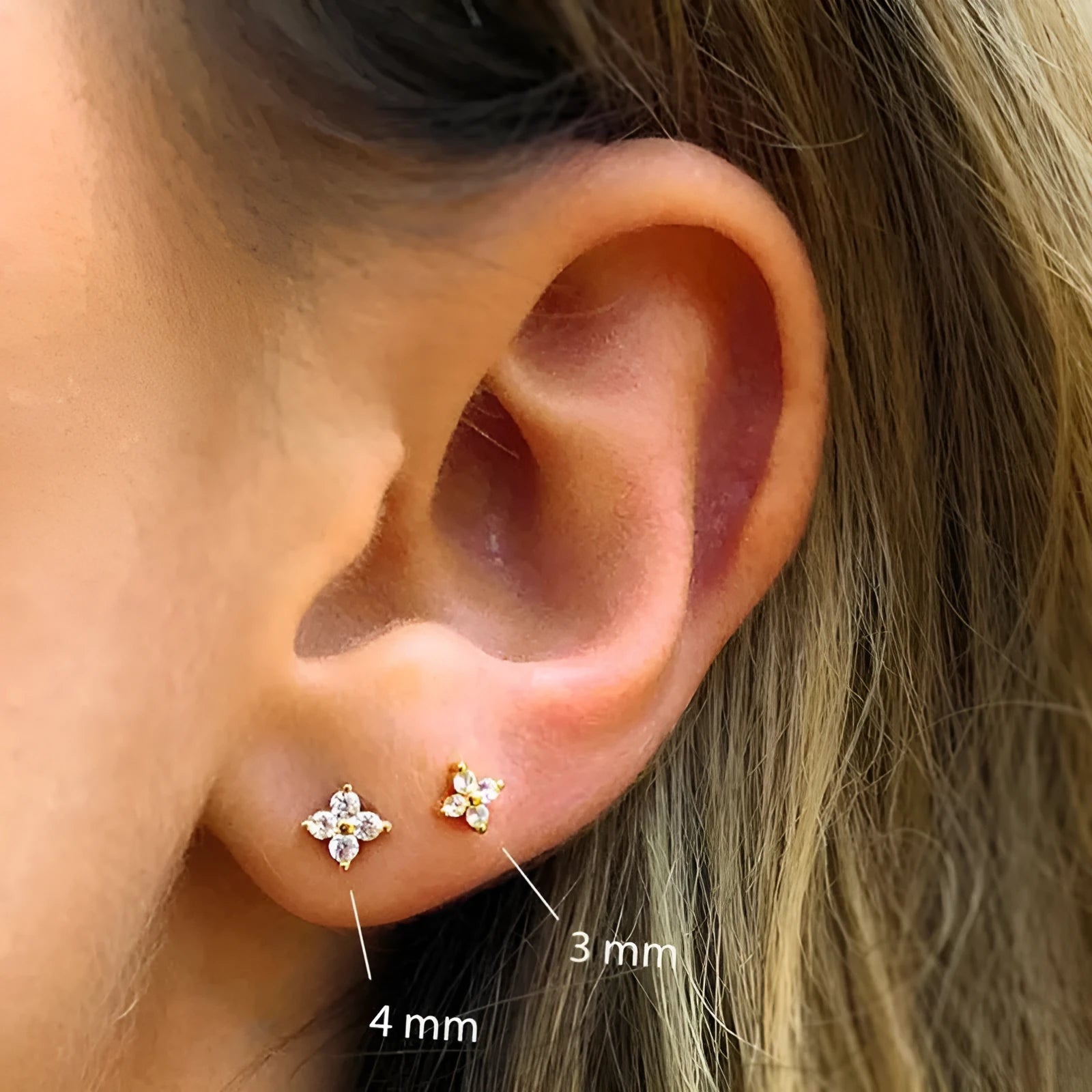 S925 sterling silver stud earrings with a geometric petal and crystal flower design in gold or platinum finish.