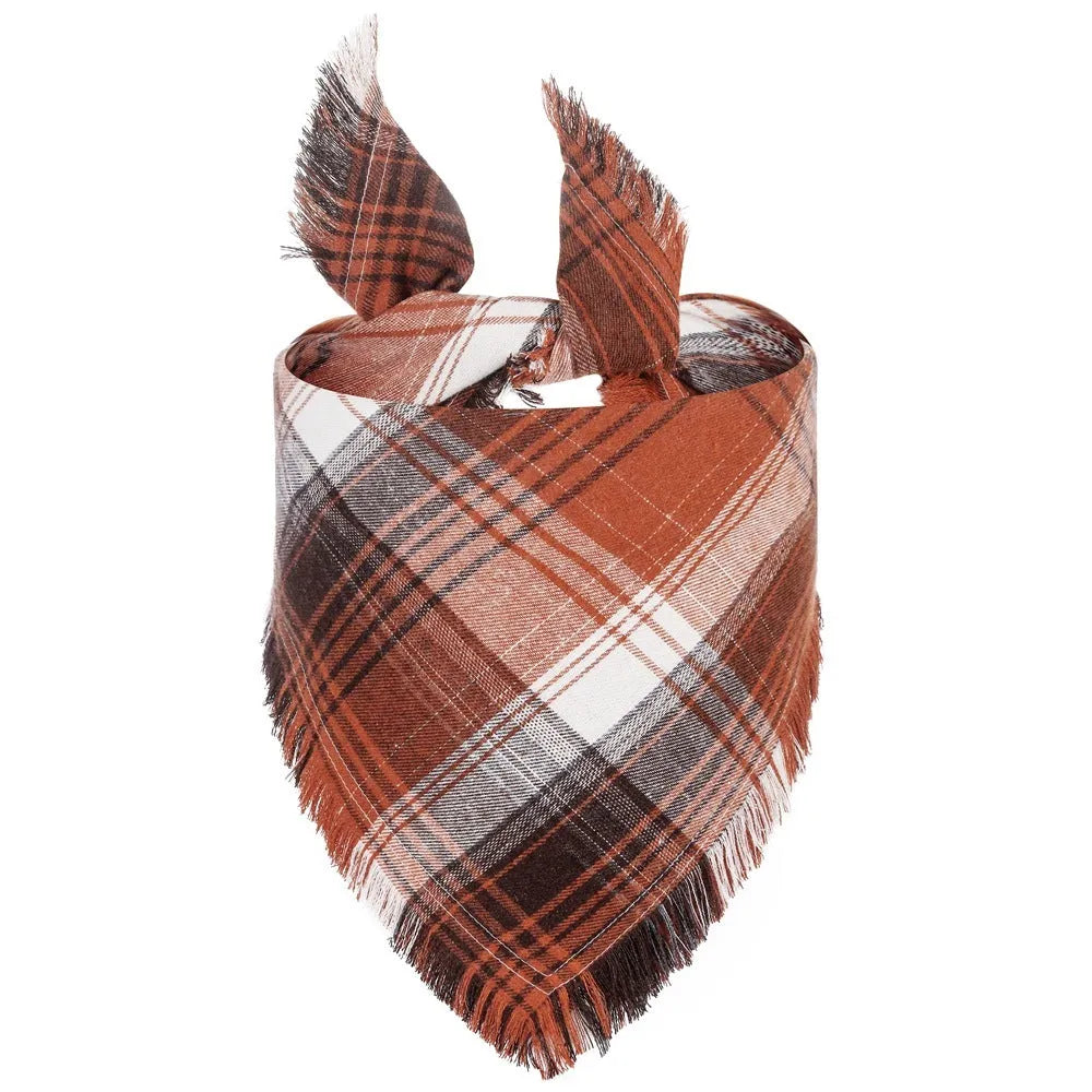 Plaid triangle dog bandana with tassel edges in autumn colours like brown, green, and orange.
