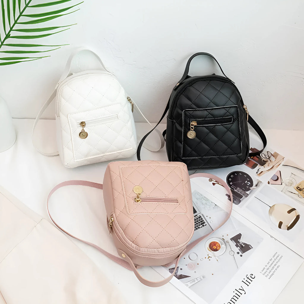 A white hard-shell girls backpack with embroidery, showing its square shape and soft top handle.