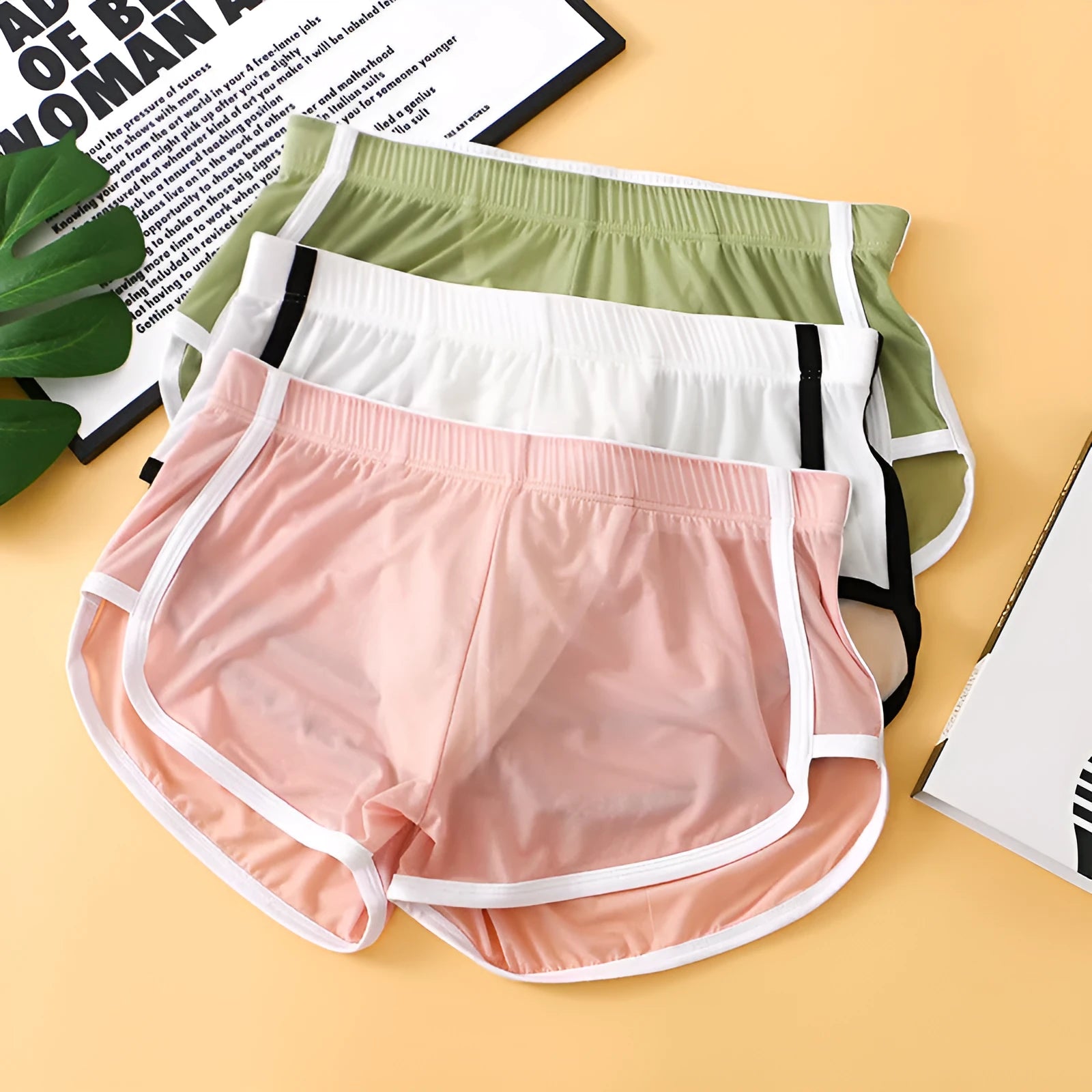 Men's low waist boxer shorts in ice silk fabric, shown in various colours including black, army green, and light purple