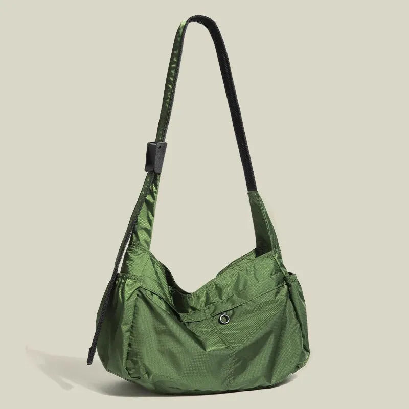 Nylon waterproof messenger bag in black with single shoulder strap and horizontal square design