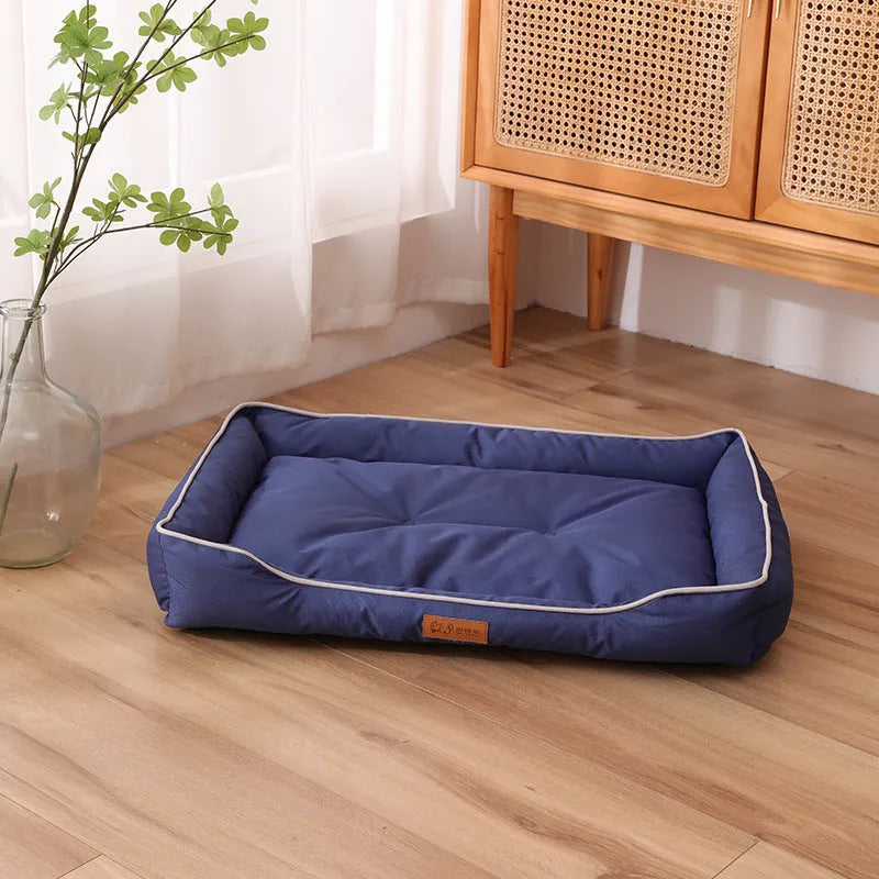 Grey waterproof dog sofa bed with a soft cushion, shown next to a sleeping golden retriever.