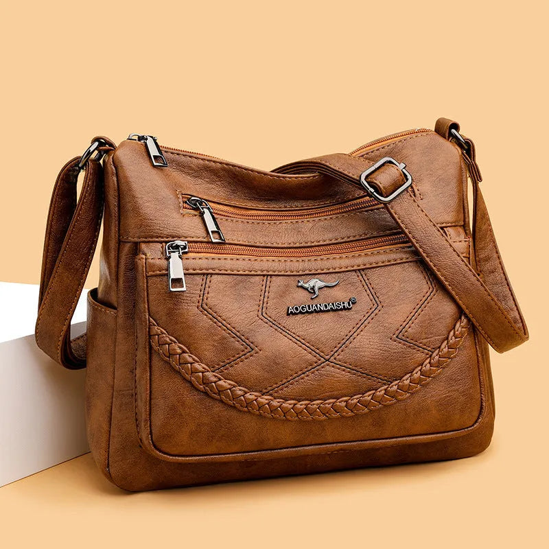 Soft leather crossbody shoulder bag in horizontal square design with zippered internal pocket