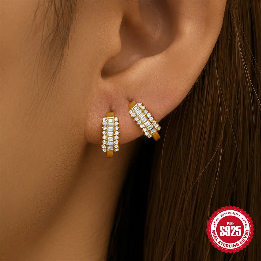 Small round sterling silver geometric stud earrings with a circle design in a gold or silver finish.
