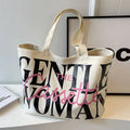 Canvas tote bag with letter print and car stitching detail in medium size 40x7x32cm available in black