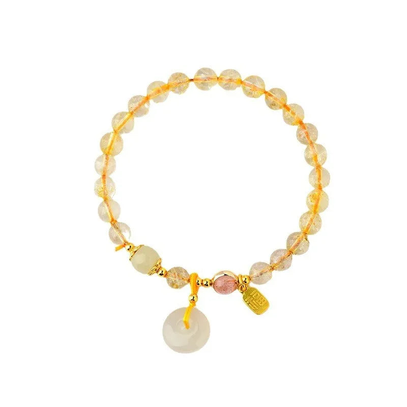 Gold rutilated quartz bracelet with safety buckle and geometric blessing card pendant.