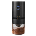 Portable black electric coffee grinder with transparent chamber and USB-C charging cable