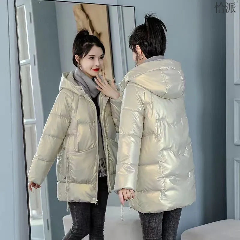 Women's green ultra-thin hooded winter jacket with long sleeves on a hanger.