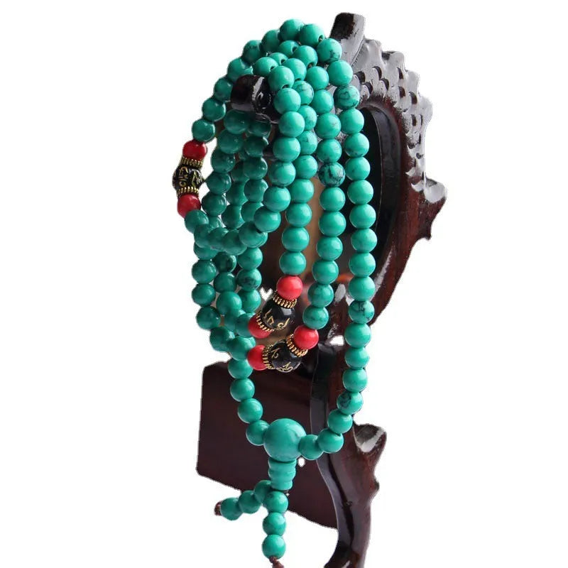 Turquoise coloured 108-bead bracelet with round synthetic stone powder beads
