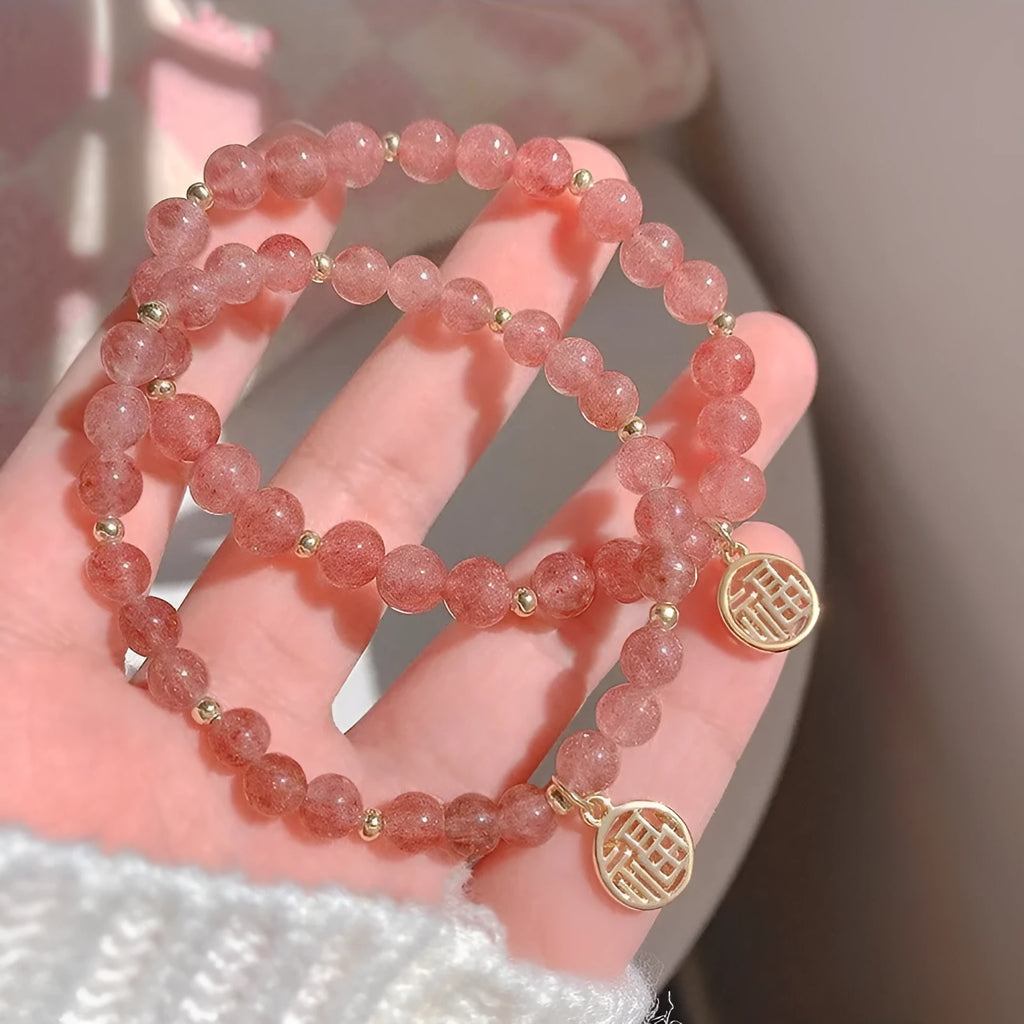 Handmade women's glass bracelet with strawberry quartz beads and blessing card