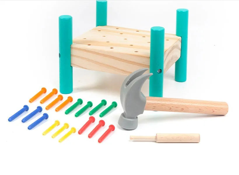 Wooden knock table with 17 colourful nails, hammer and reverse knock on khaki wood base