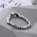 Women's handmade silver bracelet with irregular square design and elastic band