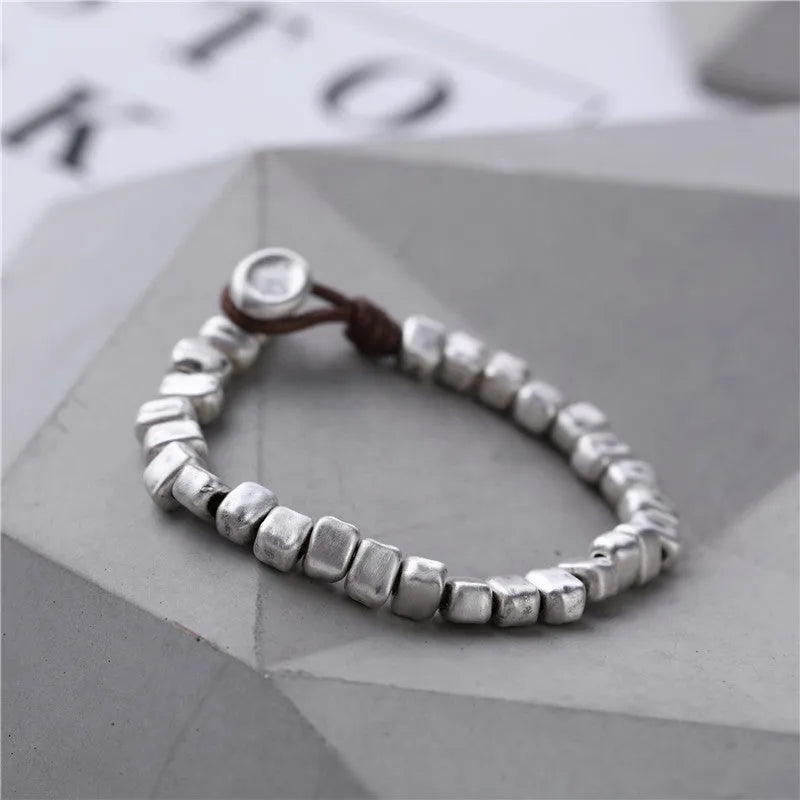 Women's handmade silver bracelet with irregular square design and elastic band