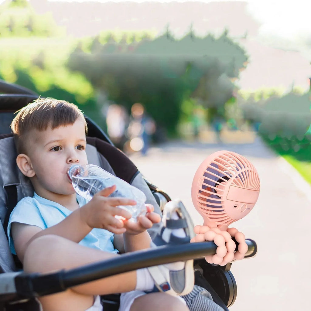 Pink portable USB rechargeable fan with animal design and clip attached to a stroller handle.