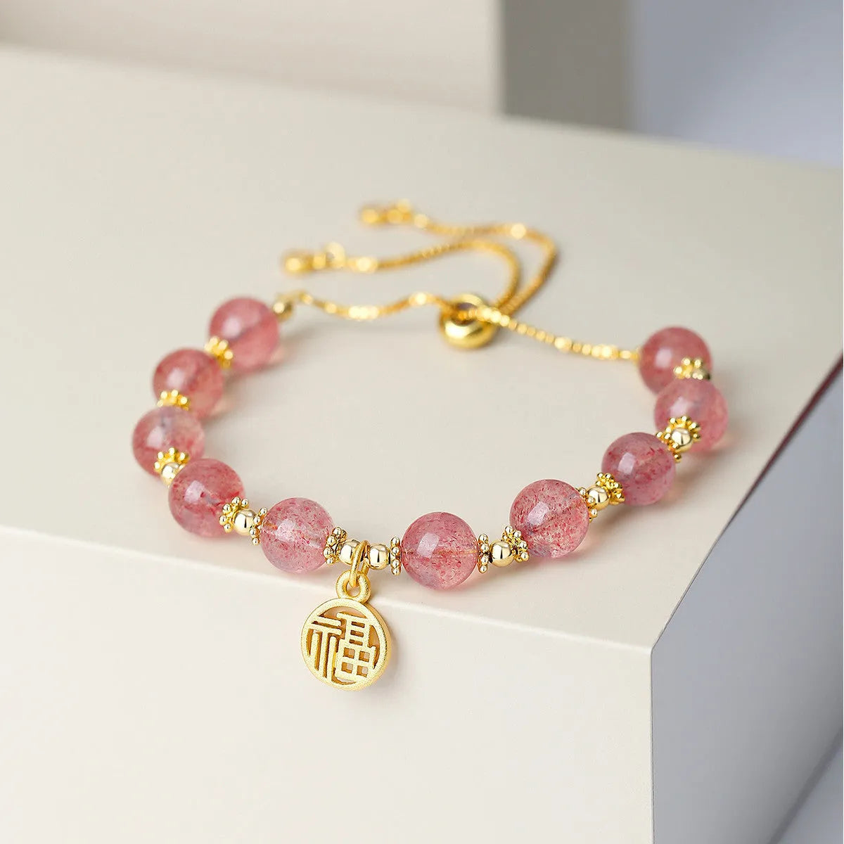 Strawberry quartz crystal bracelet with geometric fu character design and electroplated finish