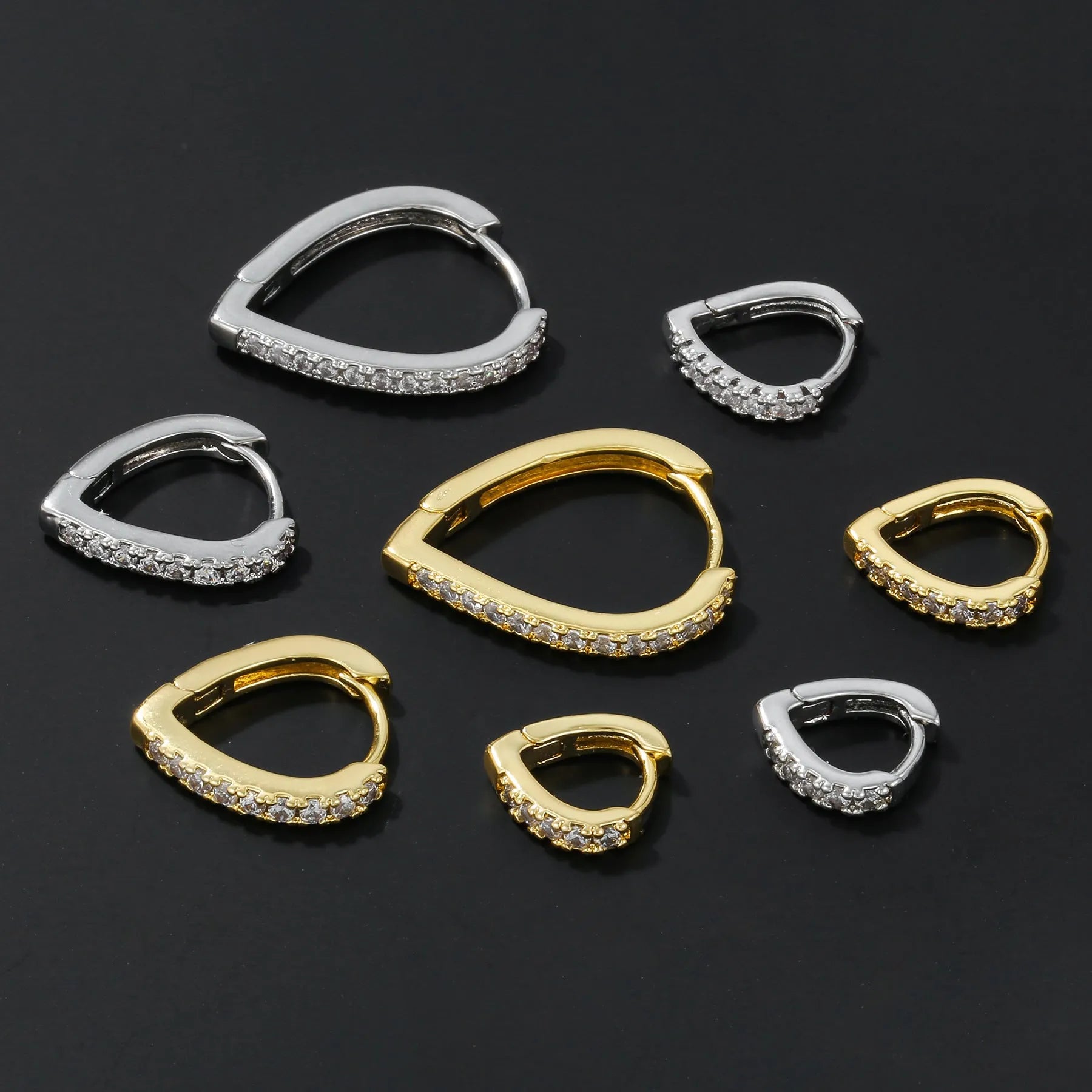 Geometrical heart-shaped gold and white gold electroplated copper ear clip for women.