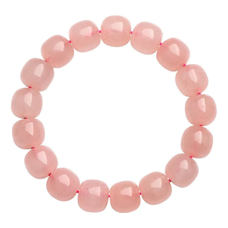 Pink natural crystal barrel bead bracelet with geometric design on wrist