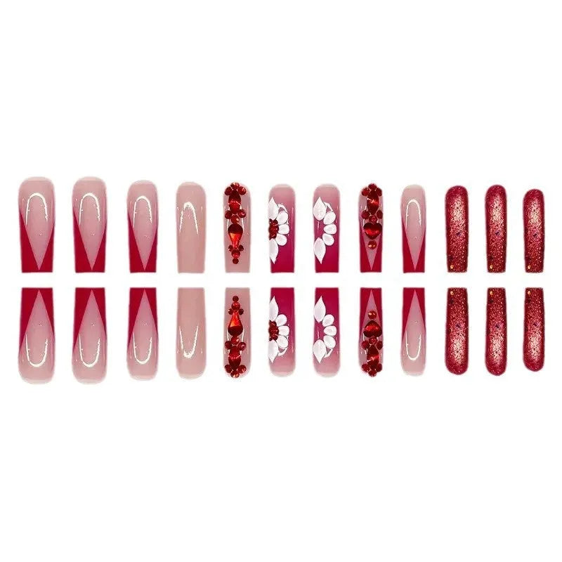 Set of sweet flower pattern press-on artificial nails with prismatic red diamonds in a long European square style.