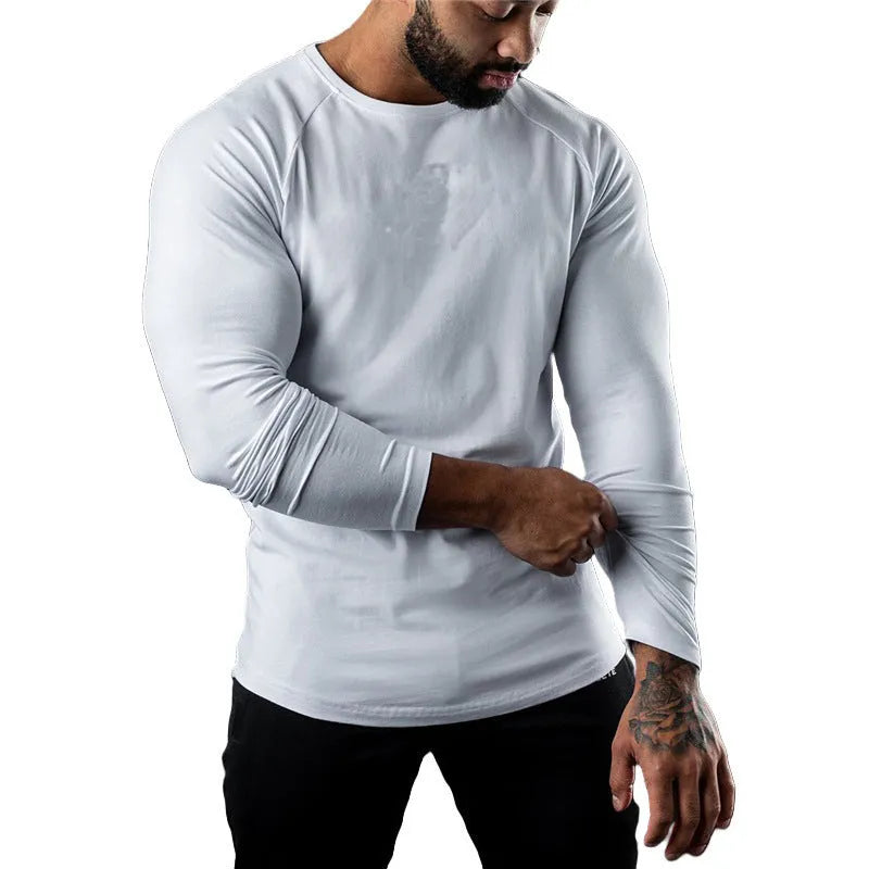 Men's tight-fitting long sleeve cotton sports t-shirt in grey, shown on a model.