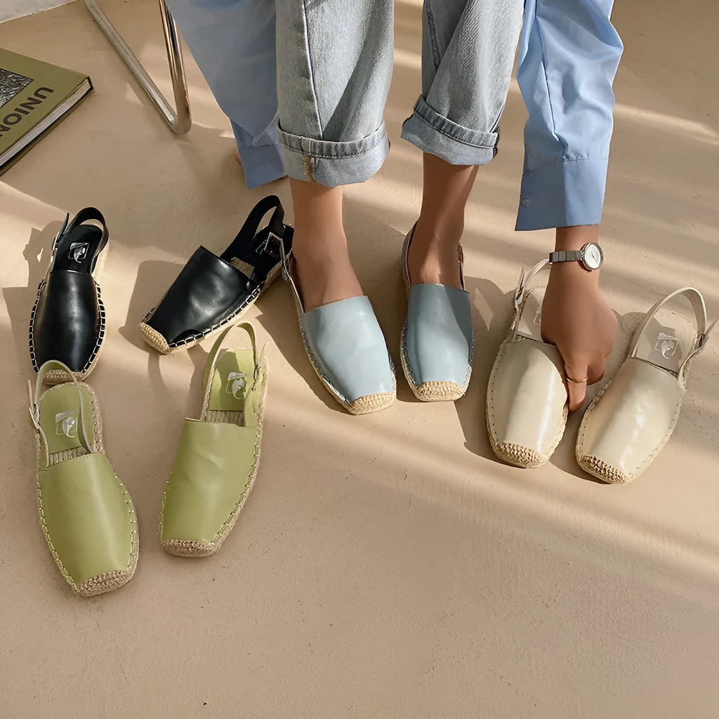 Women's beige retro-style flat sandals with an animal pattern on the canvas upper.