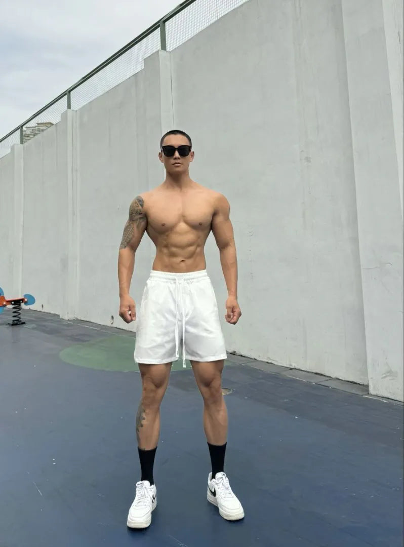 Men's ice silk nylon quarter-length shorts in light grey, laid flat to show double-layer construction.