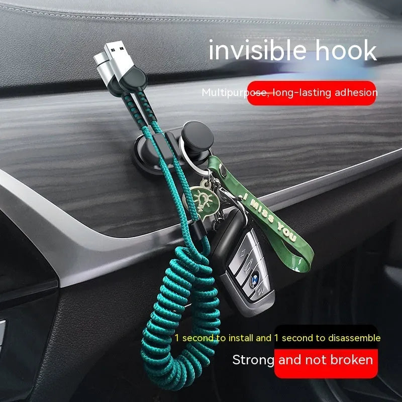 Adhesive car storage hook for cables in dark green colour showing dimensions and mounting surface