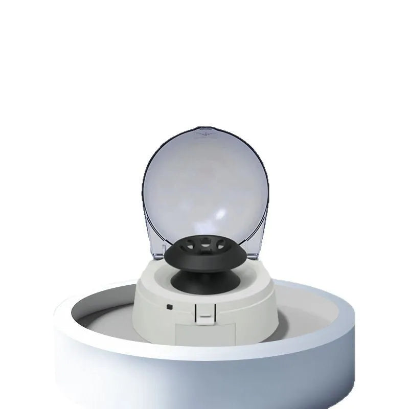 Small white mini centrifuge laboratory equipment on a benchtop