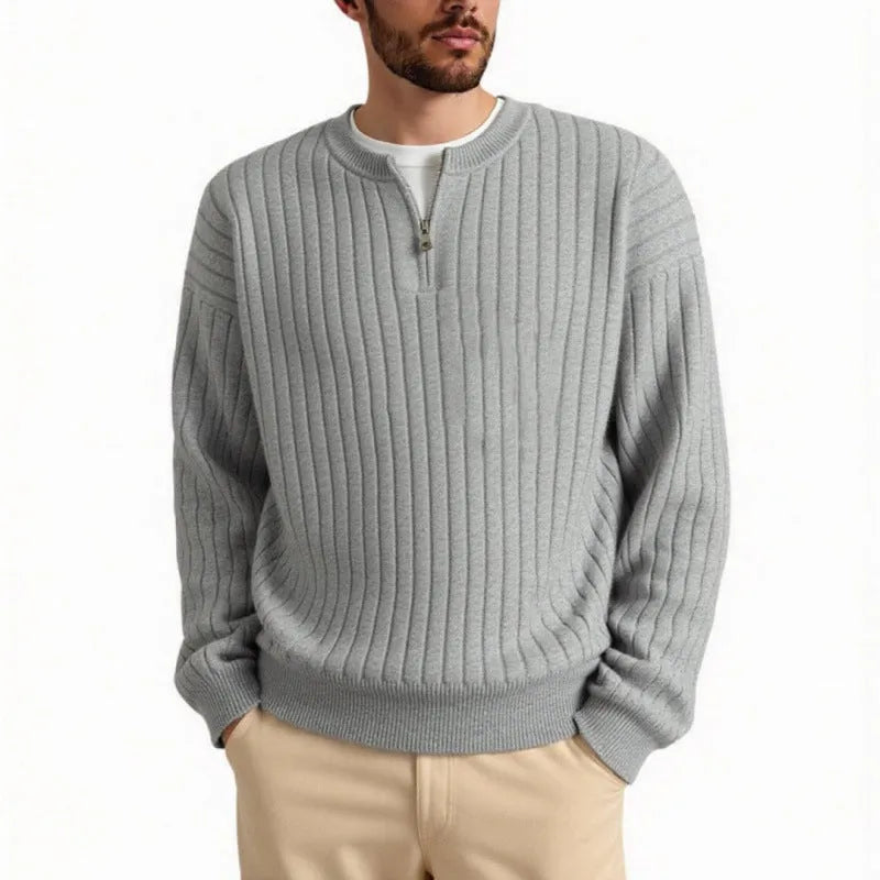 A grey men's loose fit half zip pullover sweater with a textured knit and long sleeves.