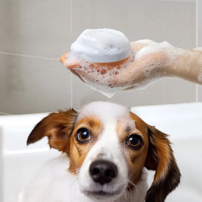 Orange TPR dog bath brush with shampoo dispenser and curved pumpkin grip design
