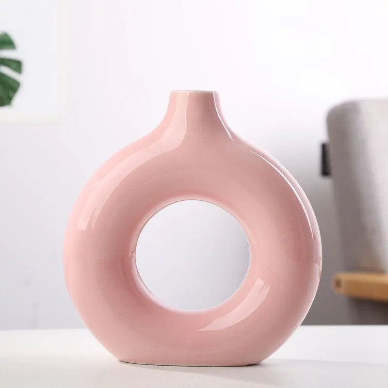Frosted unglazed porcelain biscuit vase in a simple modern style on a table.