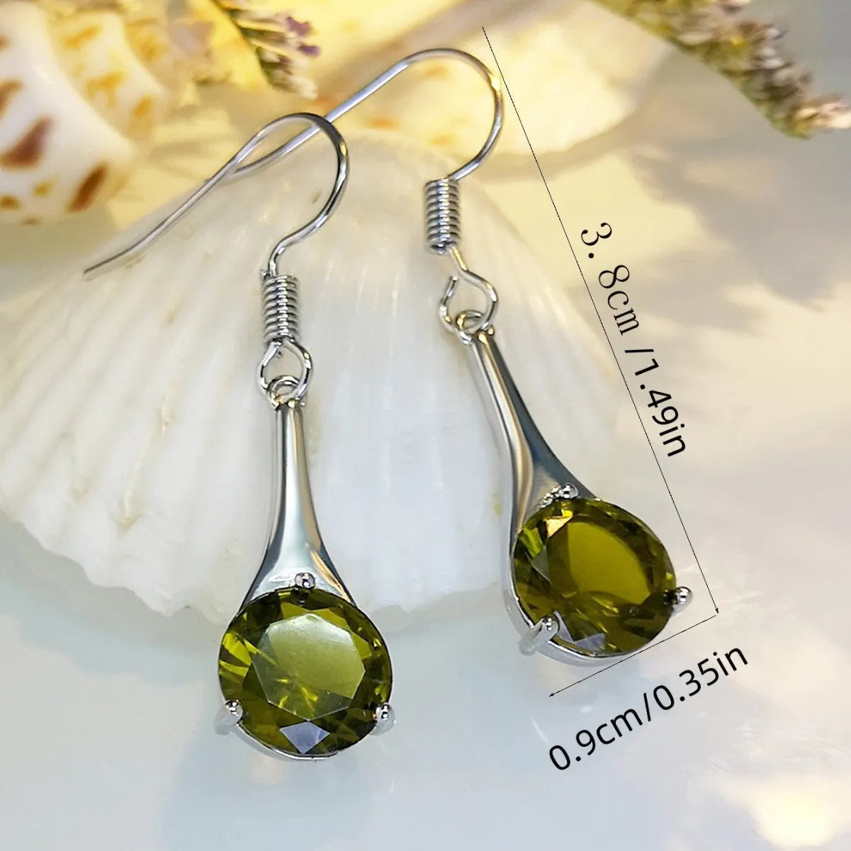 Olive green topaz coloured drop-shaped fashion earrings with a retro style on a white background.