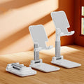 Folding telescopic mobile phone bracket in blue with anti-skid silicone pads holding smartphone