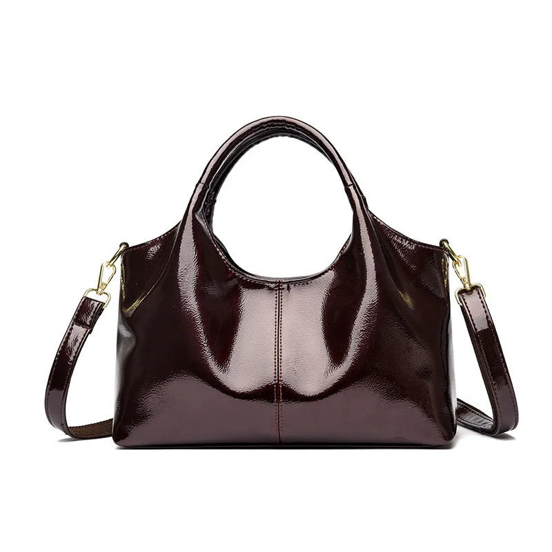 Genuine leather commuter bag with glossy finish, belt decoration, and leather grain in a horizontal square shape