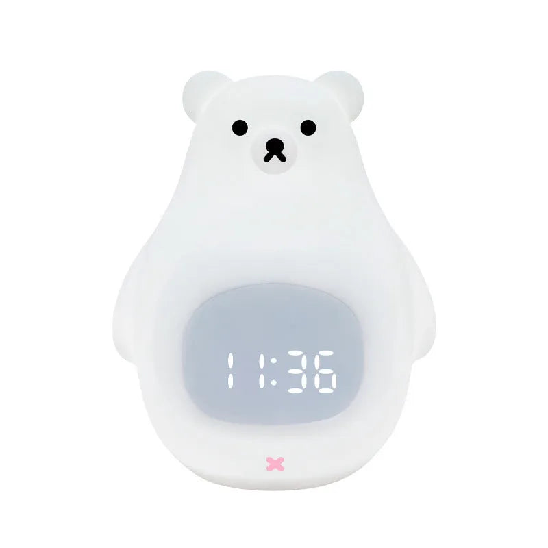 White silicone bear-shaped night light with soft glow, remote control, and button switch on a bedside table.