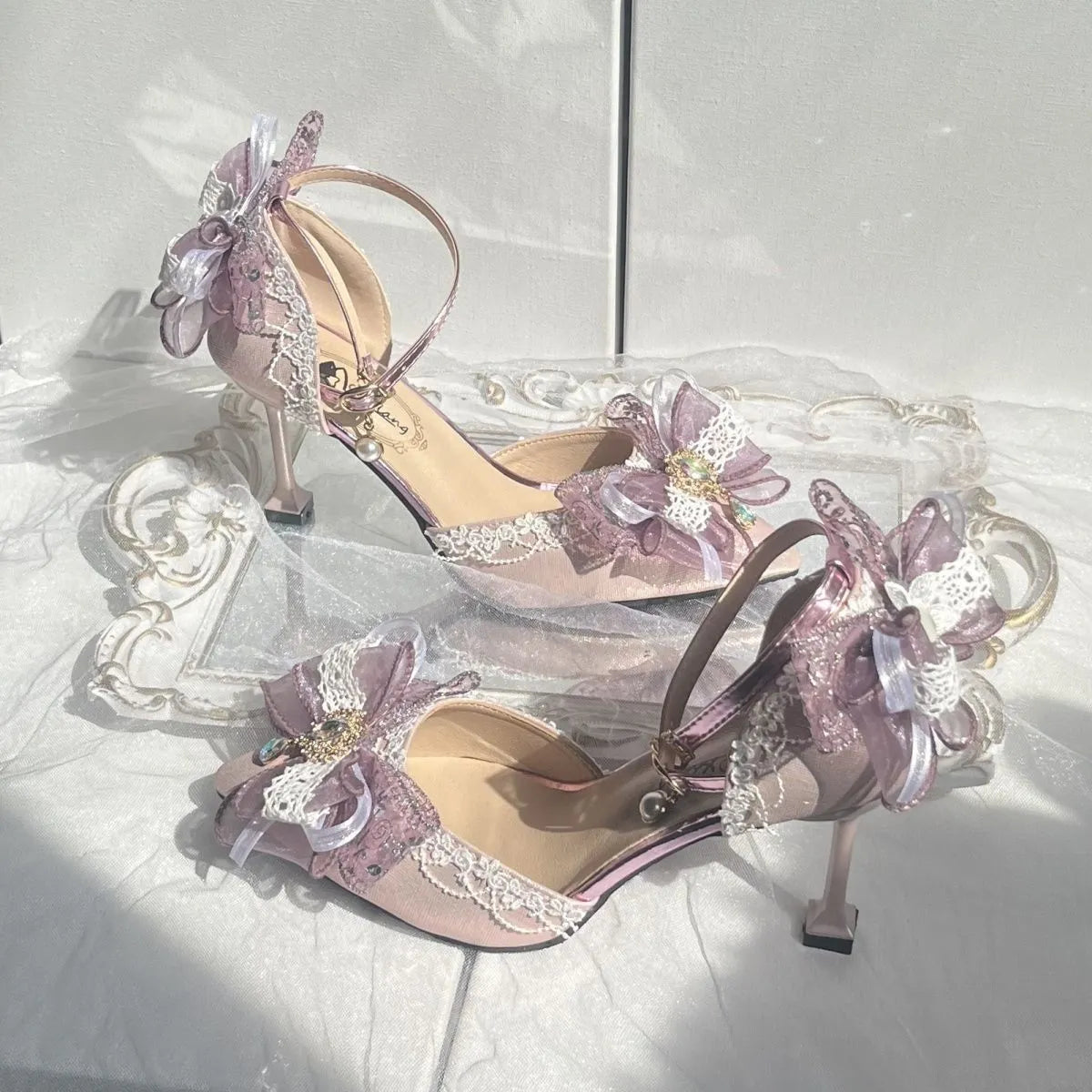 Purple satin Lolita wedding shoes with a square toe and stiletto heel on a composite sole.