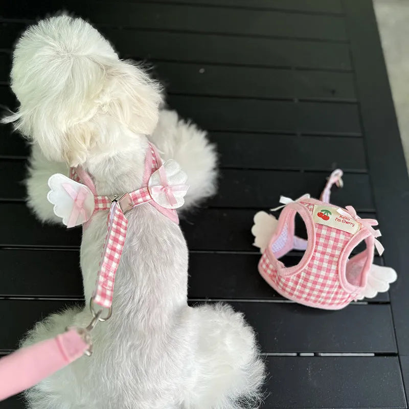 Pink cotton chest and back hand holding rope harness for a small dog on a white background.