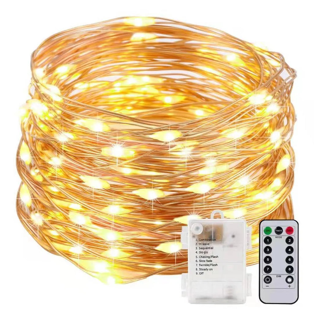 Copper wire string light with warm white LEDs wrapped around a wooden post