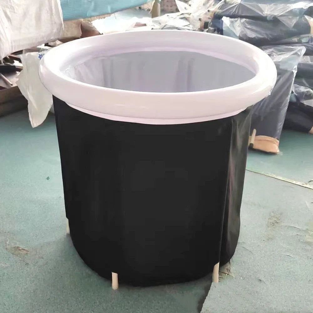 Black inflatable portable ice bath tub with elasticated cover, shown with air pump and drainage accessories