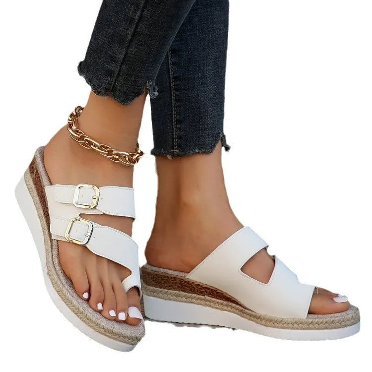 White patent leather wedge sandals with woven upper and finger fit design on a rubber sole.