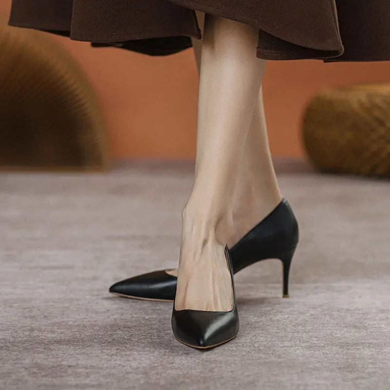 Black pointed-toe stiletto high heel pump shoes for wide feet on a plain background.