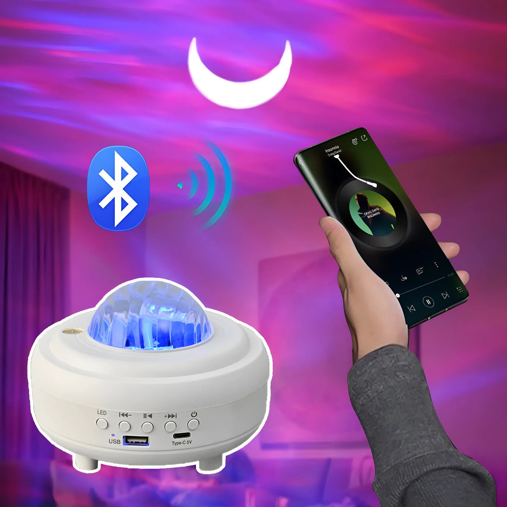 White Galaxy Star Projector Night Light on a table projecting blue starry sky onto a ceiling.