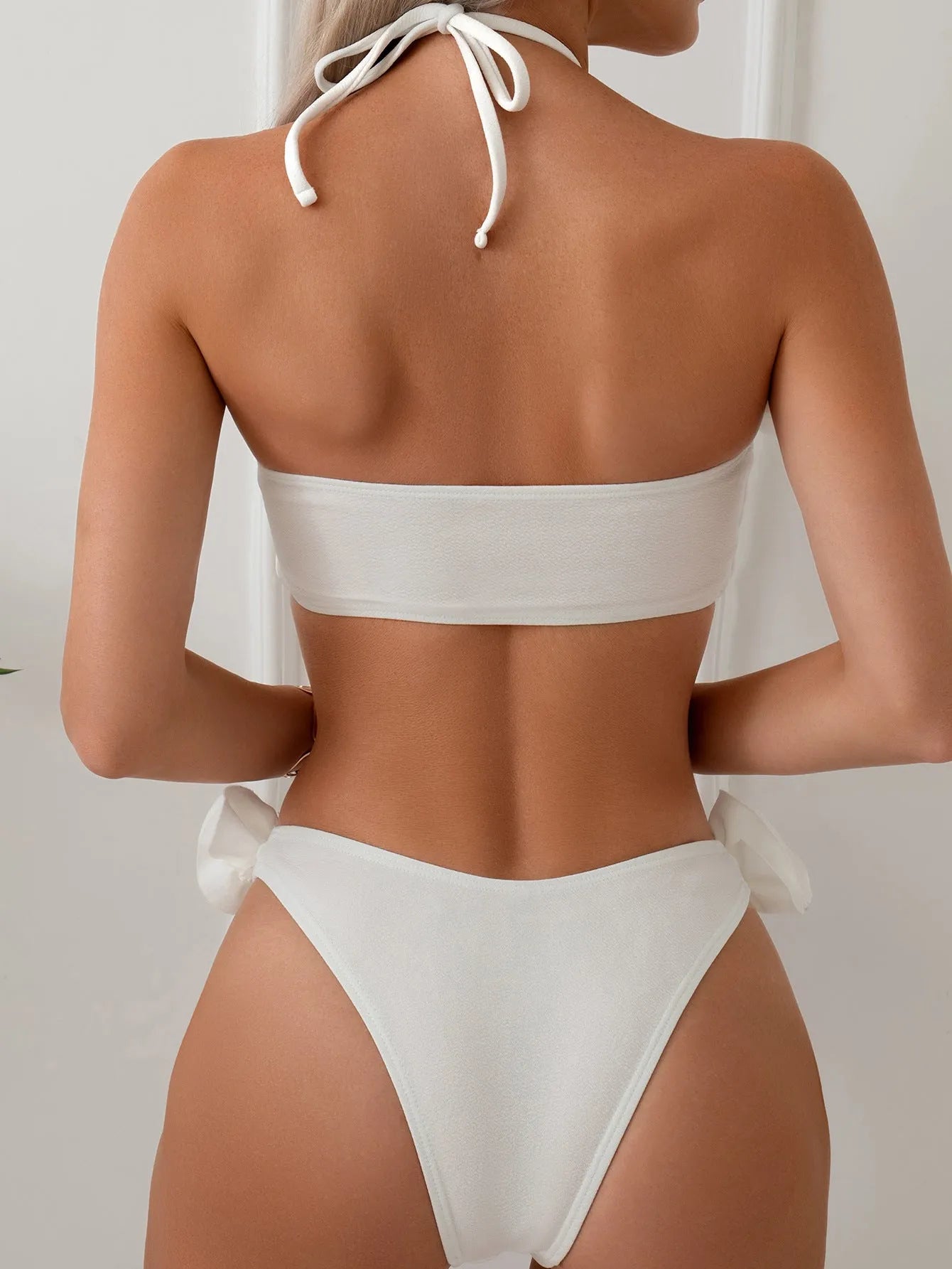 White halter neck lace-up swimsuit with three-dimensional floral pattern and split briefs style