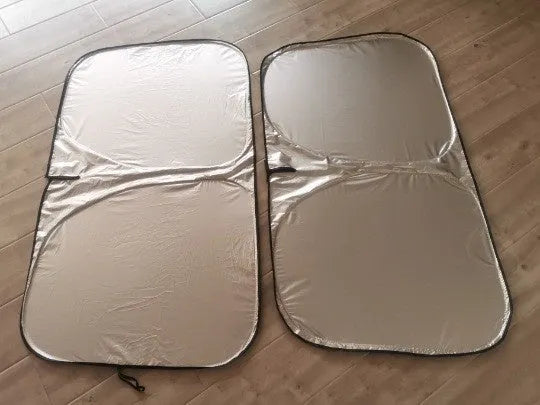 Aluminium foil car sunshade in titanium silver colour, folded flat.
