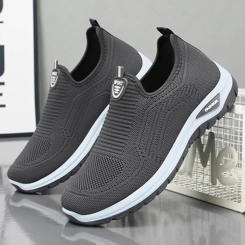 Men's black and grey breathable casual tennis shoes with mesh upper and round toe.