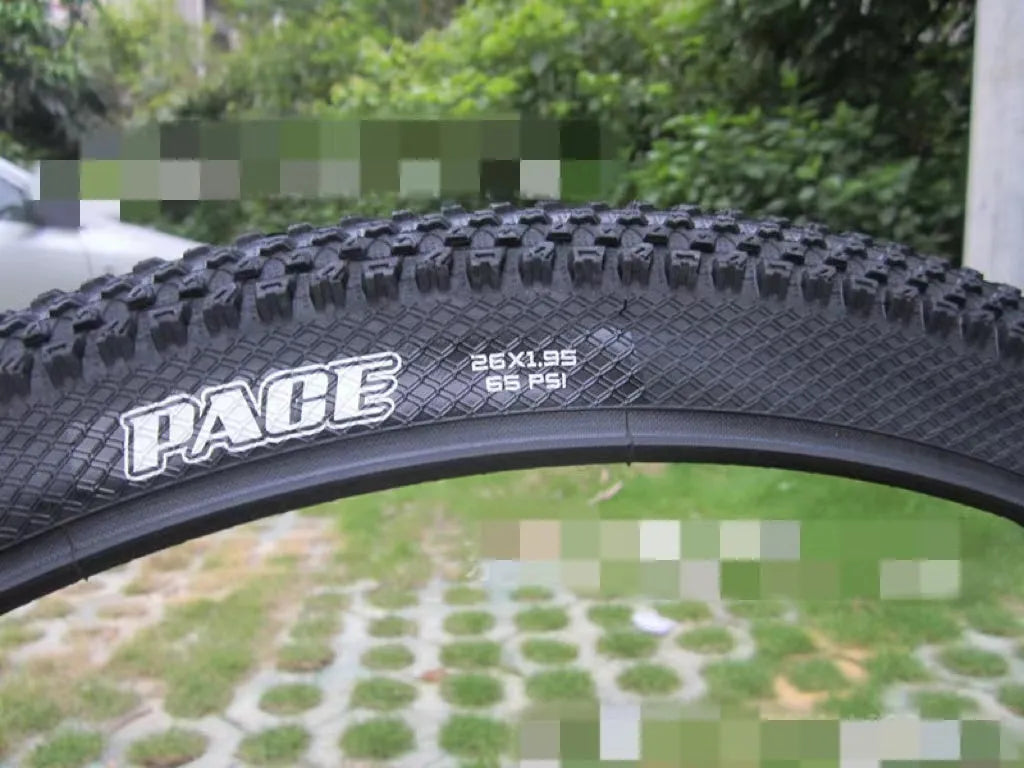 A mountain bike tyre showing tread pattern, with options for 26, 27.5, and 29-inch wheel sizes.